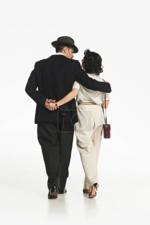 Photo for Man and woman in retro-style elegant costumes going work a walk isolated on white background. Romance. Concept of retro and vintage, fashion, romance, relationship - Royalty Free Image