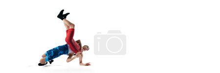 Young men, wrestling athletes competing, demonstrating strength and agility, training isolated on white background. Concept of combat sport, martial arts, competition, tournament, athleticism. Banner