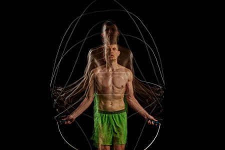 Photo for Essence of sport and athleticism. Muscular man in motion, training, doping cardio, jumping rope against black background with stroboscope effect. Concept of sport, active and healthy lifestyle - Royalty Free Image