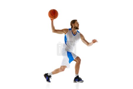 Photo for Young man, enthusiastic basketball player inn motion with ball, preparing for upcoming game,training isolated on white background. Concept of sport, competition, active and healthy lifestyle, game - Royalty Free Image