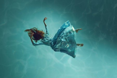 Photo for Harmony and inspiration born in the embrace of the ocean. Tender young girl levitating calmly underwater, revealing inner world. Concept of surrealism, beauty, mystery and fantasy, freedom - Royalty Free Image