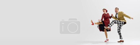 Photo for Fun and dynamic photo of young couple, artistic man and woman dancing isolated over white studio background. Concept of art, retro and vintage, hobby, entertainment, 20s. Banner. Empty space for ad - Royalty Free Image