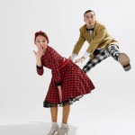 Fun and energetic retro dance scene with man and woman dressed in colorful 1950s fashion, sharing cheerful moment isolated onwhite studio background. Concept of art, retro and vintage, entertainment