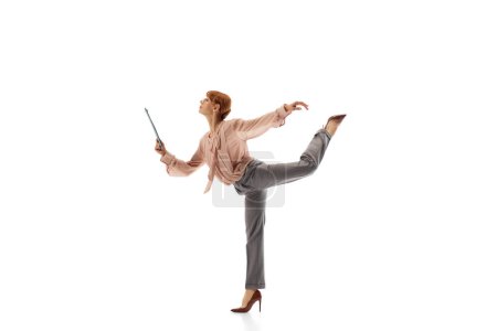 Photo for Elegant woman in formal wear, employee standing in dynamic pose on heels and looking on documents isolated on white background. Motivated worker in motion. Concept of business, office lifestyle - Royalty Free Image