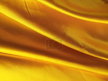 Foto de Resumen borroso patrón de tela amarilla de oro oscuro para fondo o ilustración, producto gráfico de diseño publicitario, elegante horizontal - Imagen libre de derechos
