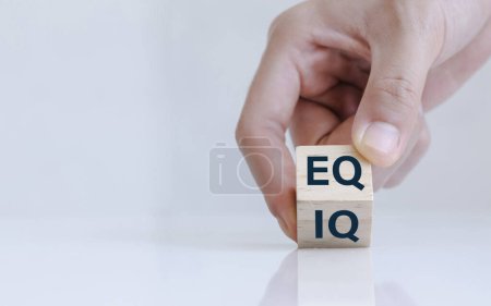 Téléchargez les photos : Close up of hand change wooden cube with word IQ to EQ. Emotional intelligence and intelligence quotient - en image libre de droit