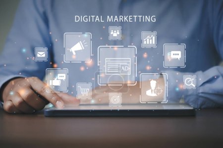 Marketer using a tablet to analyze digital online marketing and web icon for business and social media marketing, content marketing, viral, SEO, keyword, advertise, website, and internet marketing.