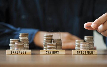 Businessmen or accountants are stacking coins to plan future financial account management. Income Management Concepts for Savings investment and expenses