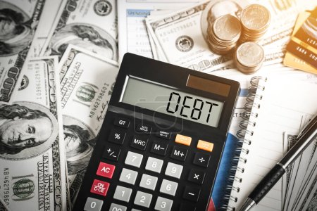 Foto de Debt word in calculator in concept Debt management and financial accounting planning, refinance household debt and credit card debt. - Imagen libre de derechos