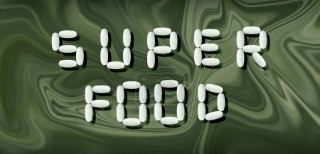 Téléchargez les photos : Le mot "superfood" est écrit dans des pilules sur un fond abstrait, bannière publicitaire - en image libre de droit