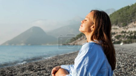 Photo for Somatic exercises, happy beautiful woman on the beach, advertising photo - Royalty Free Image