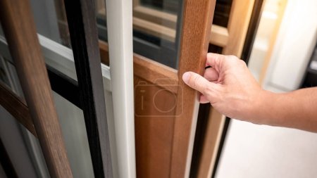 Photo for Male hand choosing cabinet panel materials or closet door for built-in furniture design. Shopping furniture and decoration. Home improvement concept - Royalty Free Image