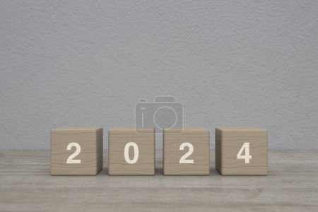 Photo for 2024 letter on wood block cubes on wooden table over grey wall background, Happy new year 2024 cover concept - Royalty Free Image