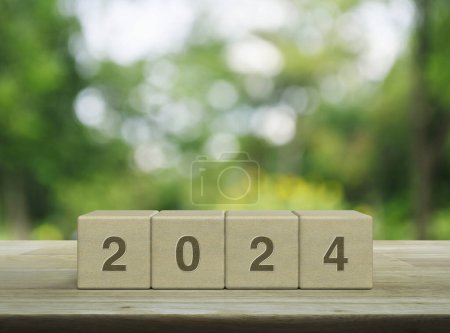 Photo for 2024 letter on wood block cubes on wooden table over blur green tree in park, Happy new year 2024 cover concept - Royalty Free Image