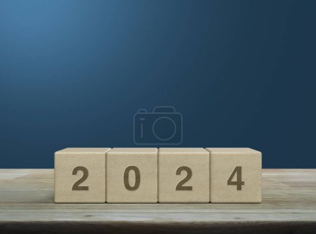 Photo for 2024 letter on wood block cubes on wooden table over light blue wall, Happy new year 2024 cover concept - Royalty Free Image