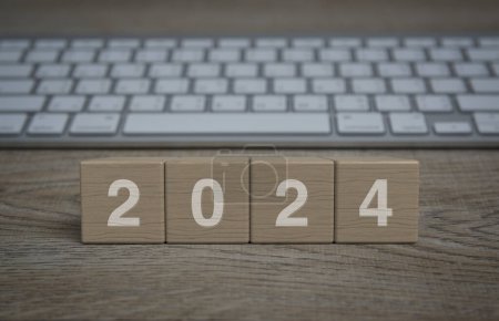 Photo for 2024 letter on wood block cubes on wooden table with modern computer keyboard, Happy new year 2024 business online concept - Royalty Free Image