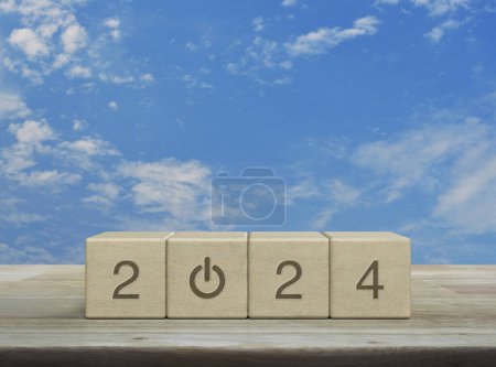 Photo for 2024 start up business icon on wood block cubes on wooden table over blue sky with white clouds, Happy new year 2024 success concept - Royalty Free Image