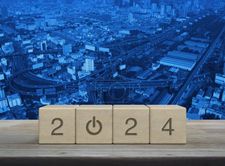 Photo for 2024 start up business icon on wood block cubes on wooden table over modern city tower, street, expressway and skyscraper, Happy new year 2024 success concept - Royalty Free Image