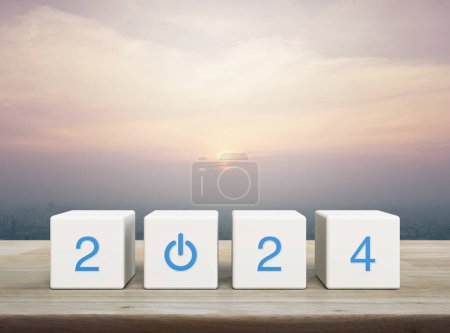 Photo for 2024 start up business icon on white block cubes on wooden table over modern city tower and skyscraper at sunset, vintage style, Happy new year 2024 success concept - Royalty Free Image
