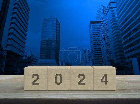 Photo for 2024 letter on wood block cubes on wooden table over modern office city tower and skyscraper, Happy new year 2024 cover concept - Royalty Free Image