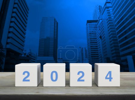 Photo for 2024 letter on white block cubes on wooden table over modern office city tower and skyscraper, Happy new year 2024 cover concept - Royalty Free Image
