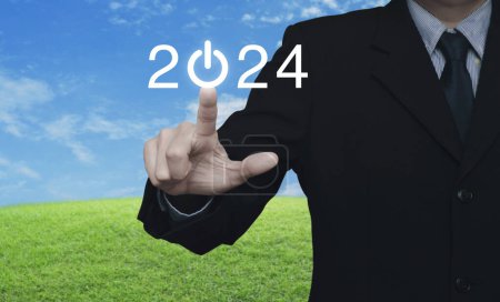Photo for Businessman pressing 2024 start up business flat icon over green grass field with blue sky, Business happy new year 2024 success concept - Royalty Free Image