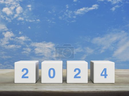 Photo for 2024 letter on white block cubes on wooden table over blue sky with white clouds, Happy new year 2024 cover concept - Royalty Free Image