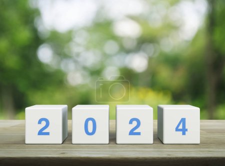 Photo for 2024 letter on white block cubes on wooden table over blur green tree in park, Happy new year 2024 cover concept - Royalty Free Image