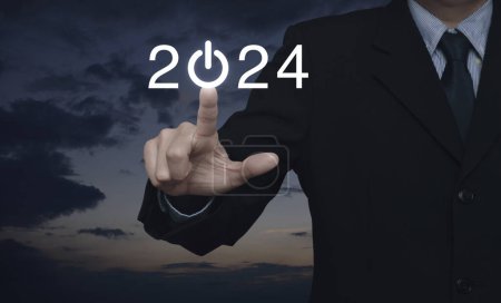 Photo for Businessman pressing 2024 start up business flat icon over sunset sky, Business happy new year 2024 success concept - Royalty Free Image