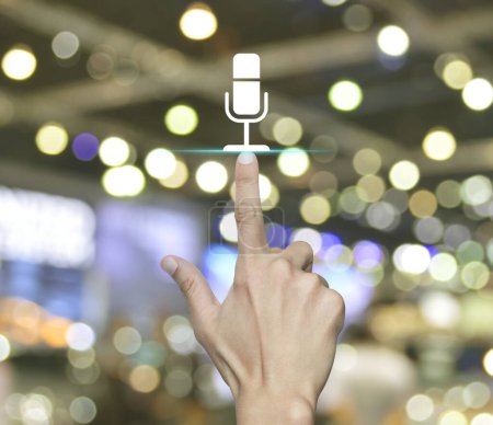 Hand pressing microphone flat icon over blur light and shadow of shopping mall, Business communication concept