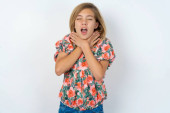 beautiful caucasian teen girl wearing flowered blouse over white wall shouting suffocate because painful strangle. Health problem. Asphyxiate and suicide concept. puzzle #659789764