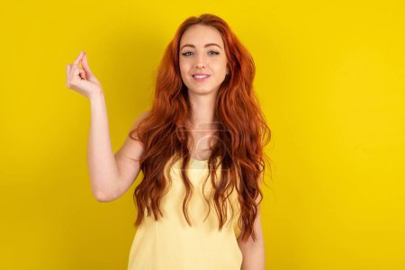 Photo for Beautiful red haired woman wearing yellow shirt over yellow studio background pointing up with hand showing up seven fingers gesture in Chinese sign language Q. - Royalty Free Image