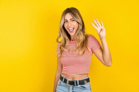 Photo for Caucasian woman showing and pointing up with fingers number four while smiling confident and happy. - Royalty Free Image