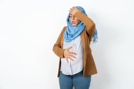 Photo for Pregnant muslim woman wearing hijab  Touching forehead for illness and fever, flu and cold, virus sick. - Royalty Free Image