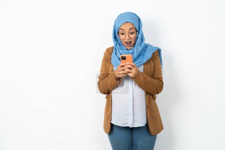 Photo for Beautiful pregnant muslim woman wearing hijab  using mobile phone chatting free time . - Royalty Free Image
