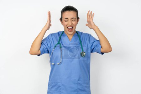 Photo for Arab  woman doctor in  uniform with stethoscope goes crazy as head goes around feels stressed because of horrible situation - Royalty Free Image