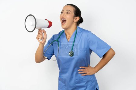 Photo for Funny arab woman doctor in  uniform with stethoscope  sincere emotions lifestyle concept. Mock up copy space. Screaming in megaphone. - Royalty Free Image
