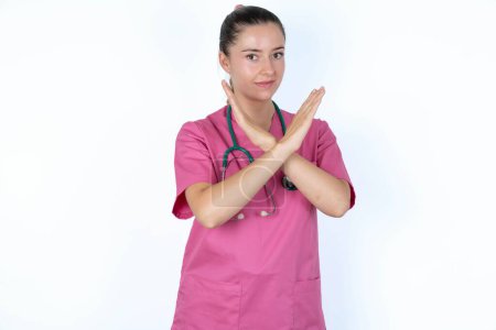 Photo for Caucasian female doctor Has rejection angry expression on face and crossing hands doing refusal negative sign. - Royalty Free Image