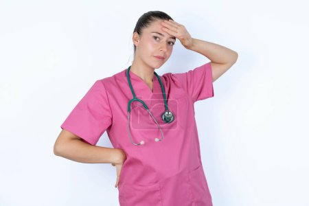 Photo for Caucasian female doctor wiping forehead with hand making phew gesture, expressing relief feels happy that he prevented huge disaster. It was close enough - Royalty Free Image