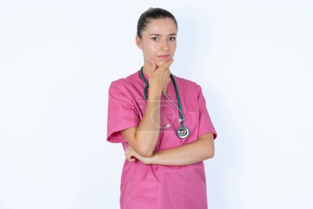Photo for Caucasian female doctor covering mouth with hands scared from something or someone bite nails - Royalty Free Image
