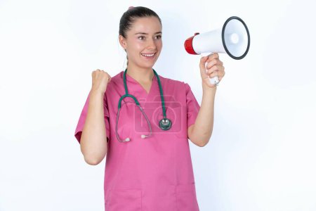 Photo for Caucasian female doctor communicates shouting loud holding a megaphone, expressing success and positive concept, idea for marketing or sales. - Royalty Free Image