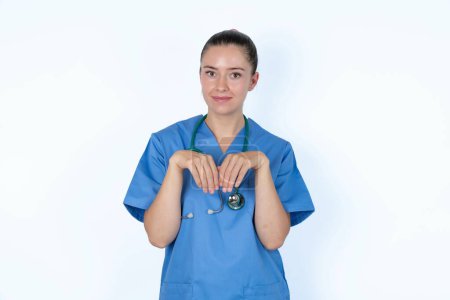 Photo for Caucasian female doctor makes bunny paws and looks with innocent expression plays with her little kid - Royalty Free Image