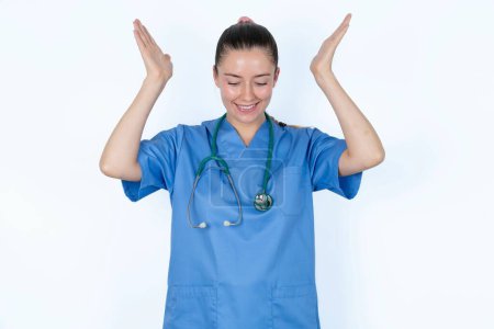 Photo for Caucasian female doctor goes crazy as head goes around feels stressed because of horrible situation - Royalty Free Image