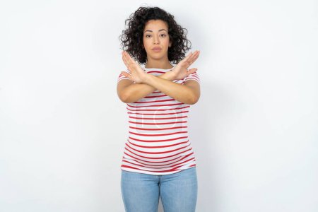 Photo for Pregnant woman has rejection expression crossing arms and palms doing negative sign, angry face. - Royalty Free Image