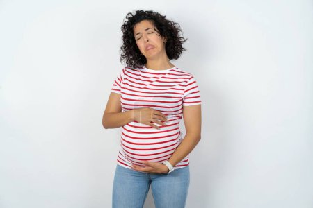 Photo for Dismal gloomy rejected pregnant woman has problems and difficulties, curves lower lip and closes eyes in despair, being in depression - Royalty Free Image