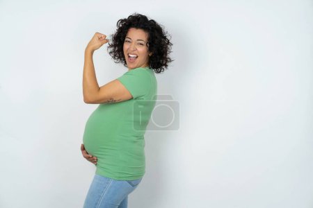 Photo for Profile side view of pregnant woman celebrates victory - Royalty Free Image