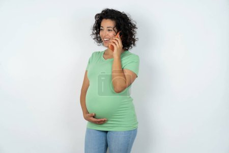 Photo for Happy joyful pregnant woman speaks on the  phone and smiling - Royalty Free Image