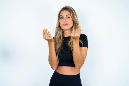 Photo for Young caucasian woman wearing sport clothes  doing money gesture with hands, asking for salary payment, millionaire business - Royalty Free Image