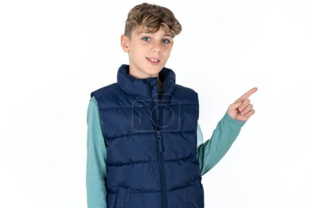 Photo for Handsome caucasian teenager boy on white studio background looking at camera indicating finger empty space sales - Royalty Free Image