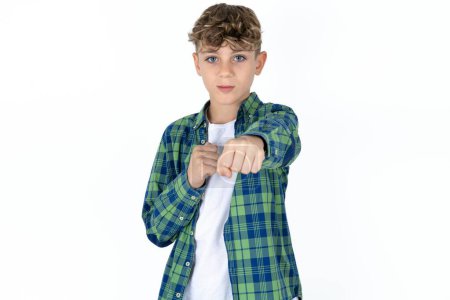 Photo for Handsome caucasian teenager boy on white studio background Punching fist to fight, aggressive and angry attack, threat and violence - Royalty Free Image